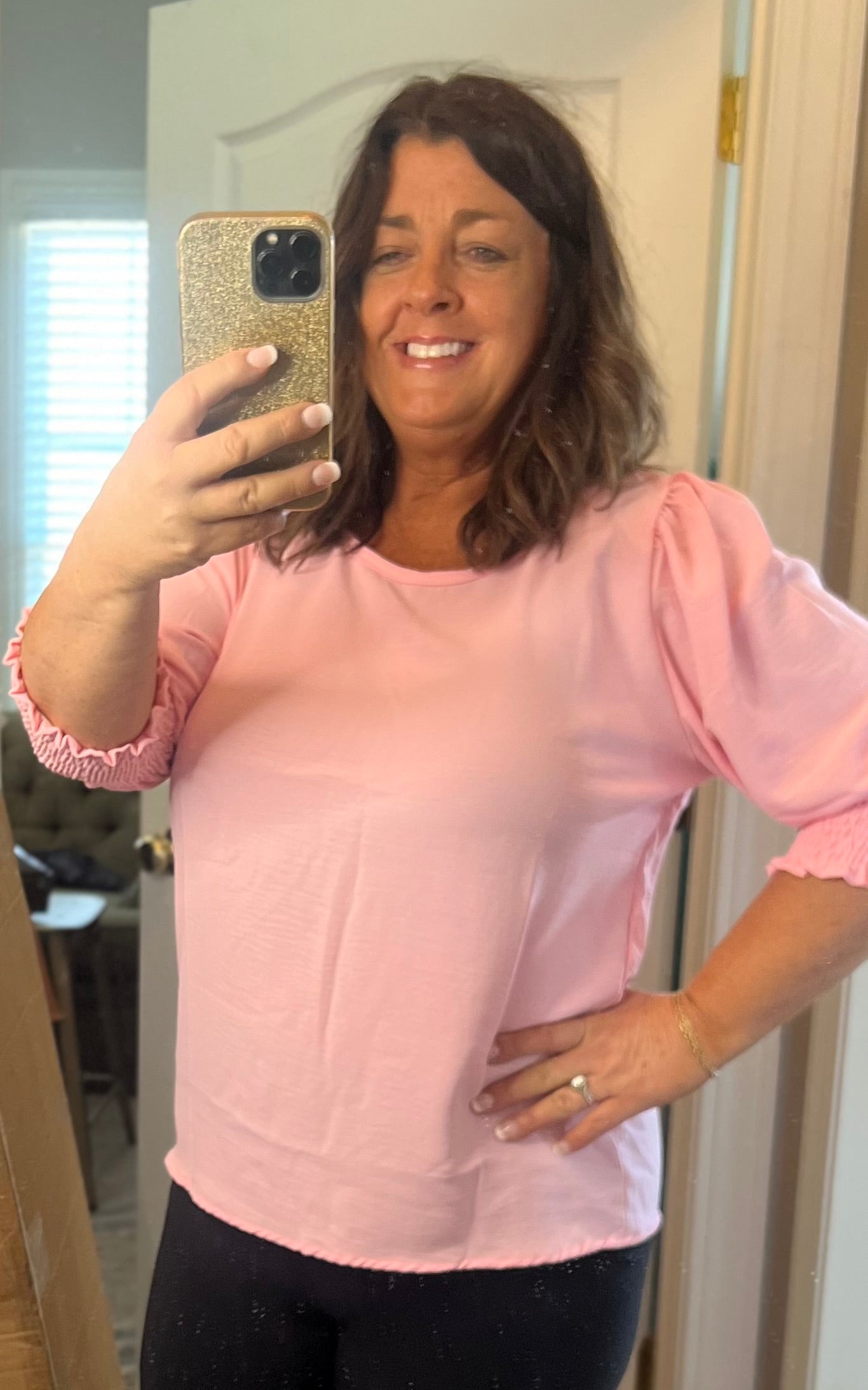 Light pink top with half sleeves and elastic around sleeves.
This is so pretty and it would look great with white pants or shorts.